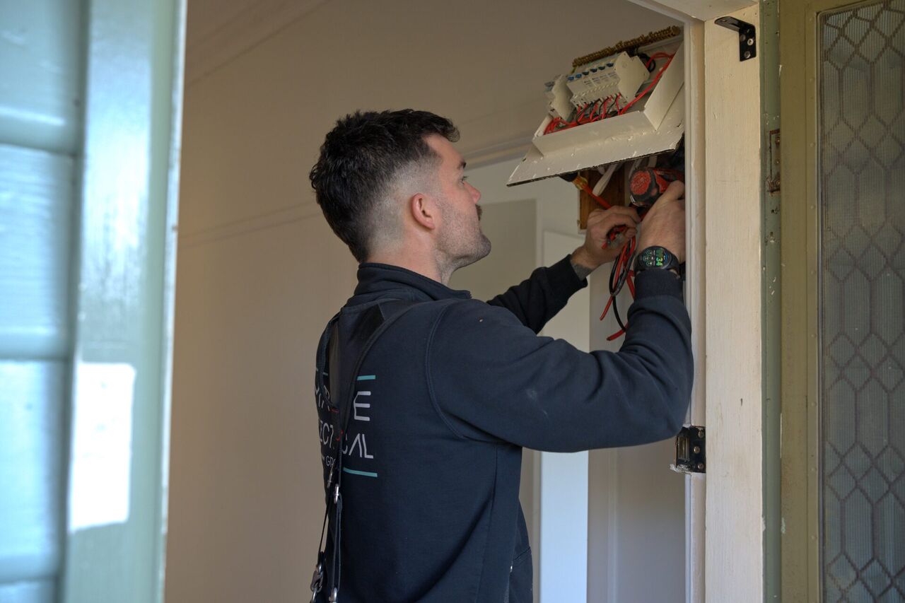 Mitch from Mathie Electrical working on a switchboard upgrade